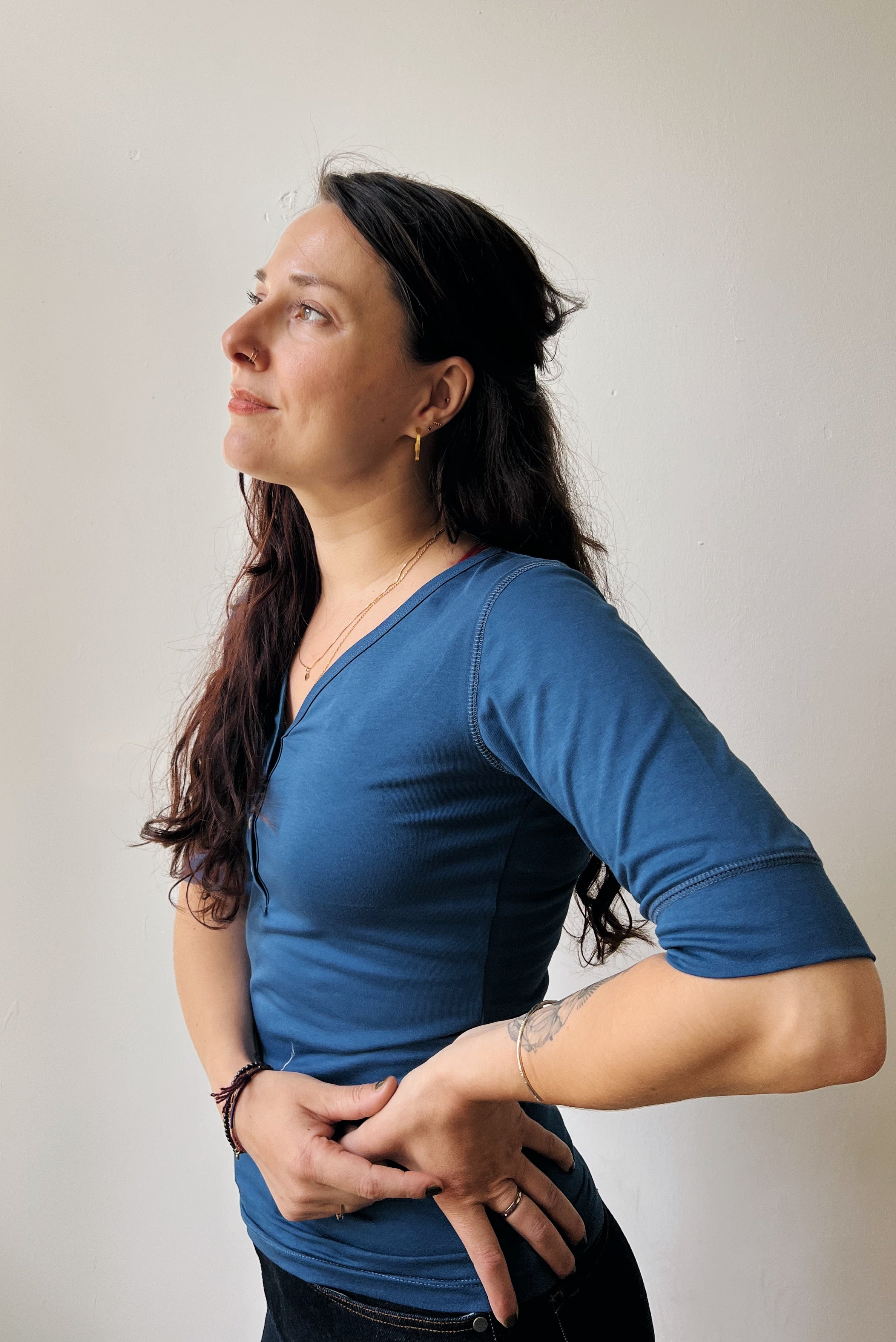 Woman wearing a blue shirt against a plain background